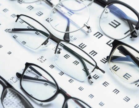 glasses-and-eye-chart-on-white-background